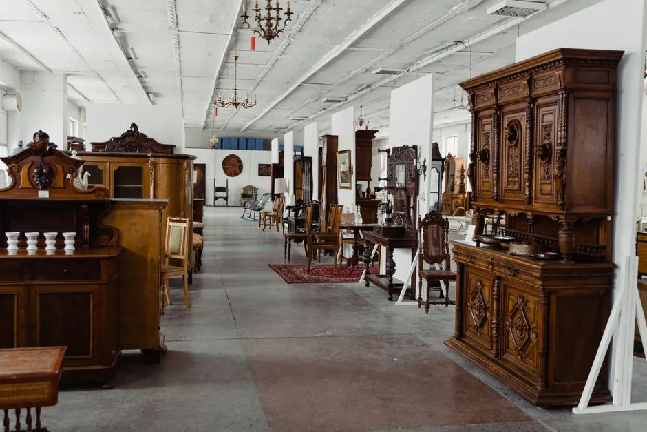 Antique wood furniture on display in a dealer's showroom